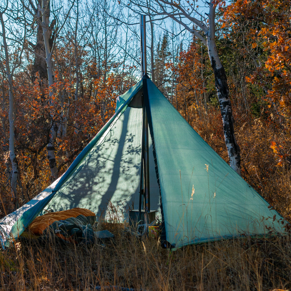 Single door dyneema Cimarron with doors open revealing tent stove and camping gear inside
