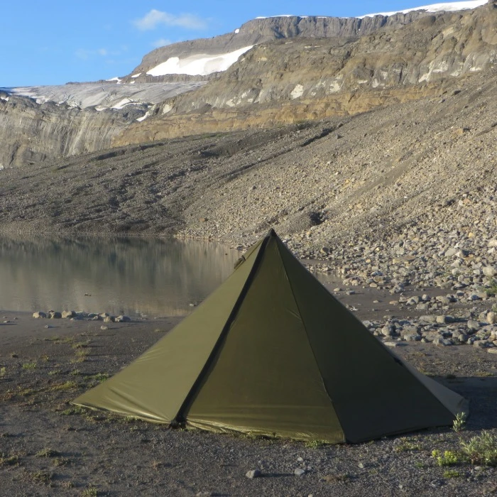 Single door 4 person cimarron light near an alpine lake with the zippers closed and the seams tight