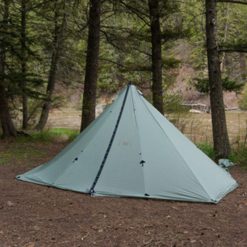 single door redcliff shelter pitched tight in a riverside campsite