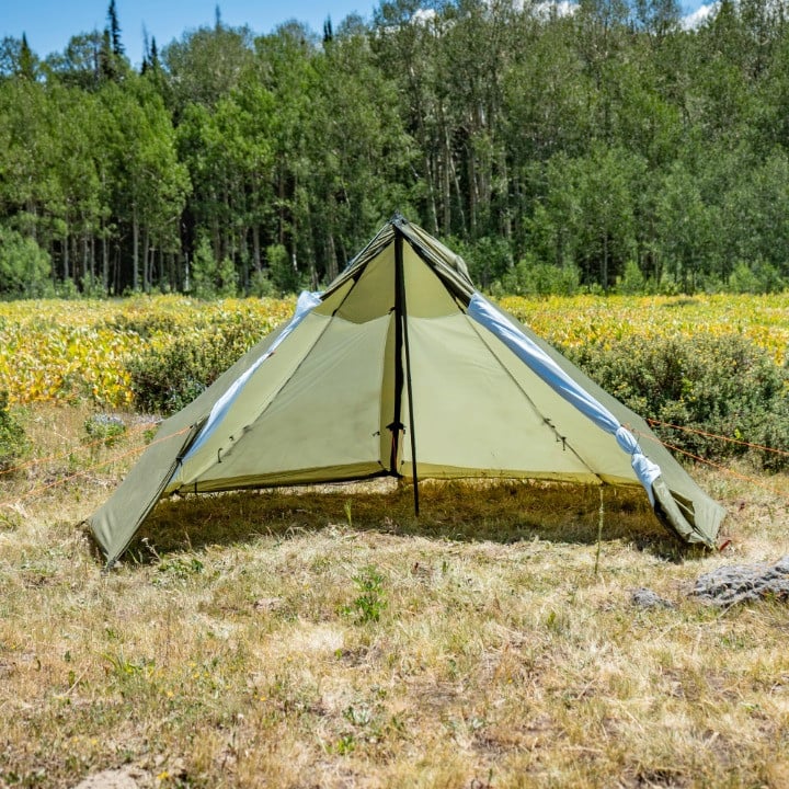 Cimarron full liner connected in a green Cimarron tent in a green alpine meadow during summer the full liner covers the entire shelter with a double wall insulation