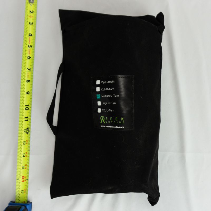 Medium U-Turn stove packed flat in storage bag showing compact packability