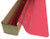 A roll of Flamingo Pink-colored window film is partially unrolled from a cardboard box.
