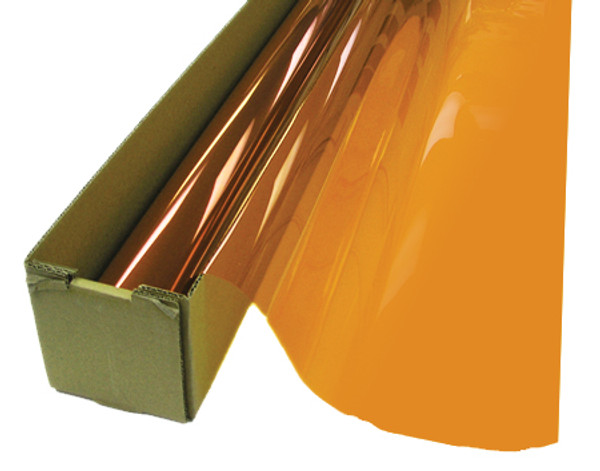A roll of Amber-colored window film is partially unrolled from a cardboard box.