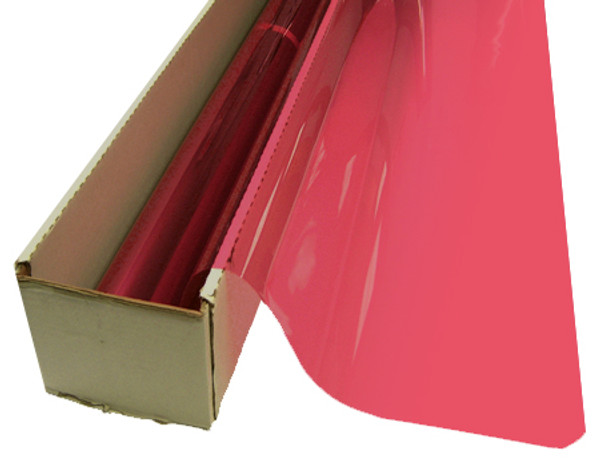 A roll of Flamingo Pink-colored window film is partially unrolled from a cardboard box.
