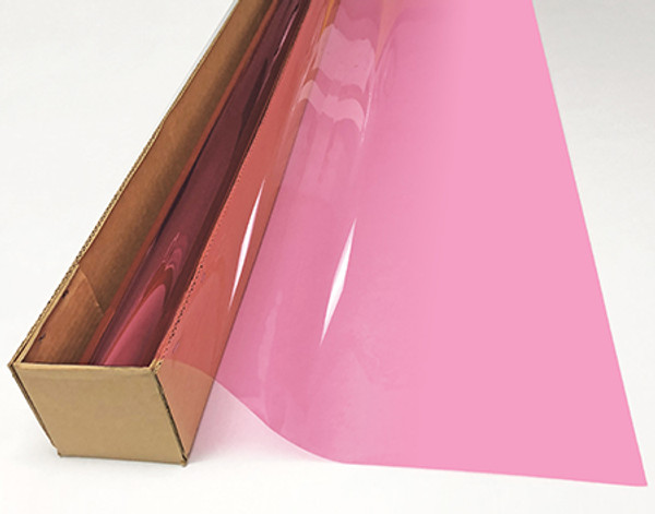 A roll of Pink-colored window film is partially unrolled from a cardboard box.