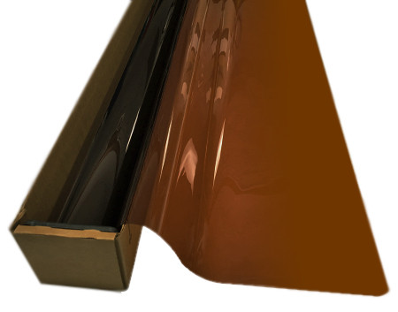 A roll of Golden Brown-colored window film is partially unrolled from a cardboard box.