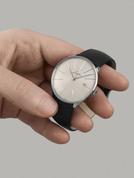 This exquisite timepiece boasts intricate details, including a flat discus-shaped case, a curved face, and a glass case back made of anti-reflective sapphire crystal. The dial features historical Junghans logo and discreet diamond-effect lines for the hour markers, adding a touch of elegance to every glance. Admire the specially developed two-armed rotor through the extra-large glass case back, showcasing the meticulous craftsmanship of this German-made watch.