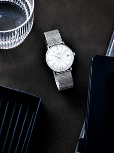 The Junghans Max Bill Kleine Automatic Ref 27/4106.46 Ladies is a watch that is known for its ladies' watches, fine jewelry, luxury watches, sunglasses, eyewear, and purses. It was originally designed by Max Bill, who was educated by the greats at Bauhaus and went on to become one of the most influential designers in Europe. The watch has a 34mm case width, an Incablock anti-shock system, a 38 hour power reserve, a silver dial color, and a gold-plated nickel balance. It also has an automatic movement with a J800.1 caliber. The Junghans Max Bill Kleine Automatic Ref 27/4106.46 Ladies is a watch that is known for its ladies' watches, fine jewelry, luxury watches, sunglasses, eyewear, and purses. It was originally designed by Max Bill, who was educated by the greats at Bauhaus and went on to become one of the most influential designers in Europe. The watch has a 34mm case width, an Incablock anti-shock system, a 38 hour power reserve, a silver dial color, and a gold-plated nickel balance. It also has an automatic movement with a J800.1 caliber.