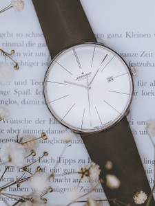 The Junghans Meister Fein Automatic is a men's watch with a modern design and a convex case and sapphire crystal that draws attention to the dial. It has a 39.5 mm polished stainless steel case with a domed and anti-reflective-coated sapphire crystal, and measures 10.3 mm in height. The watch has a 38 hour power reserve, a date function, and a reliable movement that beats at 28.8 kbh. It also has elongated hour markers and baton hands that curve down towards the edge of the dial. The watch is water resistant and scratch resistant. The Junghans Meister Fein Automatic is a men's watch with a modern design and a convex case and sapphire crystal that draws attention to the dial. It has a 39.5 mm polished stainless steel case with a domed and anti-reflective-coated sapphire crystal, and measures 10.3 mm in height. The watch has a 38 hour power reserve, a date function, and a reliable movement that beats at 28.8 kbh. It also has elongated hour markers and baton hands that curve down towards the edge of the dial. The watch is water resistant and scratch resistant.