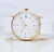 Junghans Max Bill Damen Quartz profile view with white dial and gold case, horizontal view