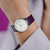 On the wrist Junghans Max Bill Damen 47/4558.02 white dial watch with purple numerals and purple leather strap