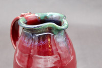 Ruby Red Pitcher with copper rim, roughly 6 inches wide (with handle) by 6.5 inches tall, (SK7857)
