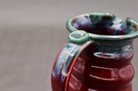 Ruby Red Pitcher with copper rim, roughly 5 inches wide (with handle) by 6.5 inches tall, (SK7895)
