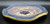 Cosmic Wall Platter (SK7188) Porcelain and Cobalt, Iron, 24 Karat gold and wood ashes, roughly 14" diameter by 2" thick, approx 10 pounds.