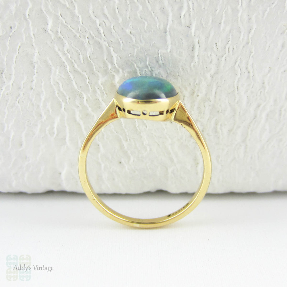 Art Nouveau Opal Doublet Ring, Black Opal Cabochon Bezel Set 18 Carat Yellow Gold Solitaire Setting, Circa 1910s.