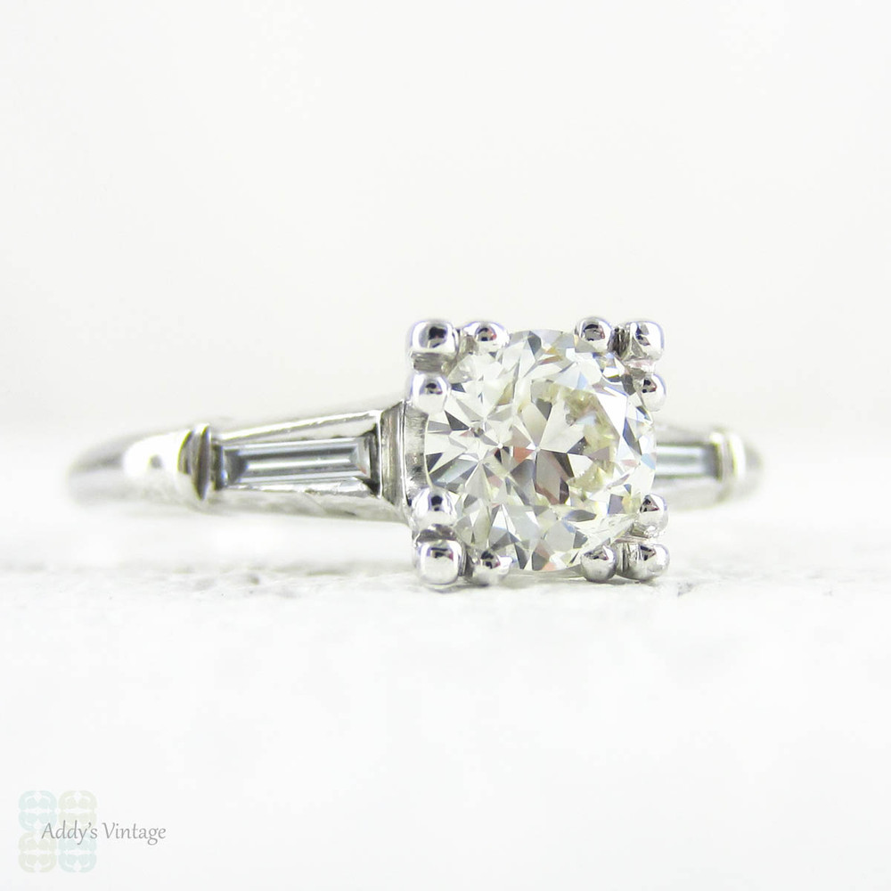 Transitional Cut Diamond Engagement Ring, Tapered Baguette Platinum Setting with Triple Claw Style Prongs, 0.86 ctw, Circa 1930s.