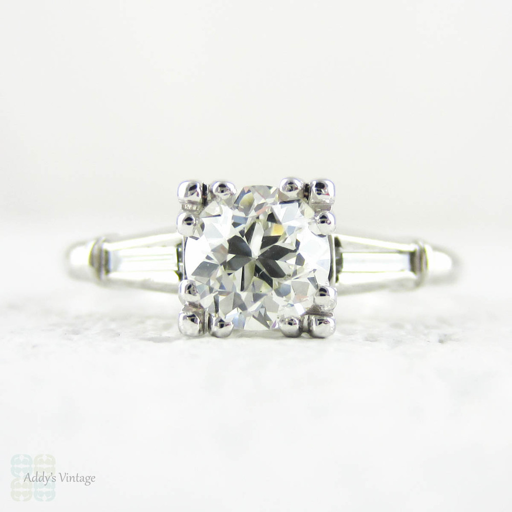 Transitional Cut Diamond Engagement Ring, Tapered Baguette Platinum Setting with Triple Claw Style Prongs, 0.86 ctw, Circa 1930s.
