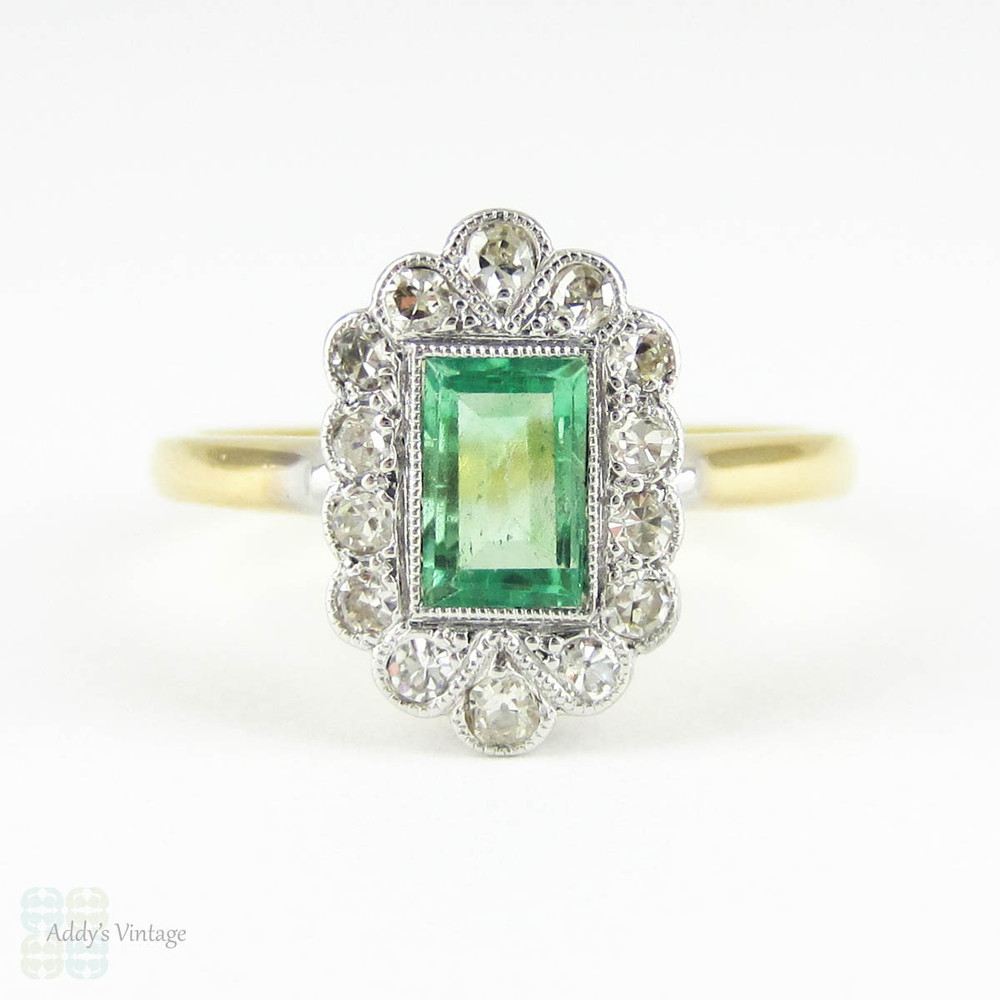 Art Deco Emerald & Diamond Engagement Ring. Light Green Emerald Cut Emerald with Fan Shaped Diamond Halo. Circa 1920s, 18ct & Platinum.