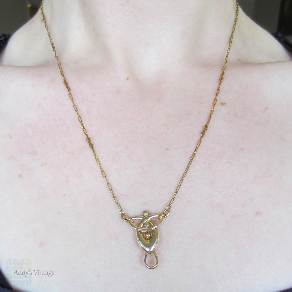 BALANCE. Art Nouveau 15ct Gold Necklace, Fancy Trombone Link Chain with Large Knot Design Pendant and Dog Clip for Pendant, Circa 1910s.