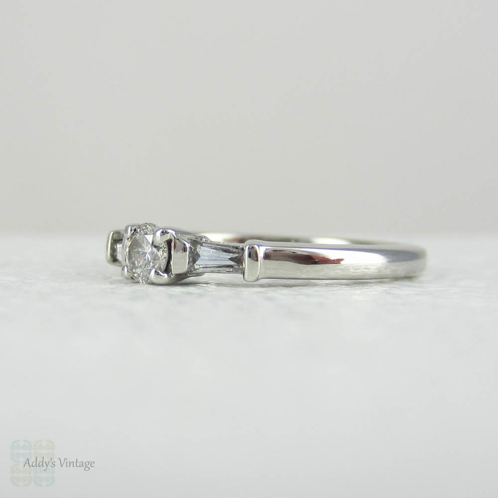 Estate Platinum Round Brilliant Diamond Engagement Ring with Tapered Baguette Accent Diamonds.