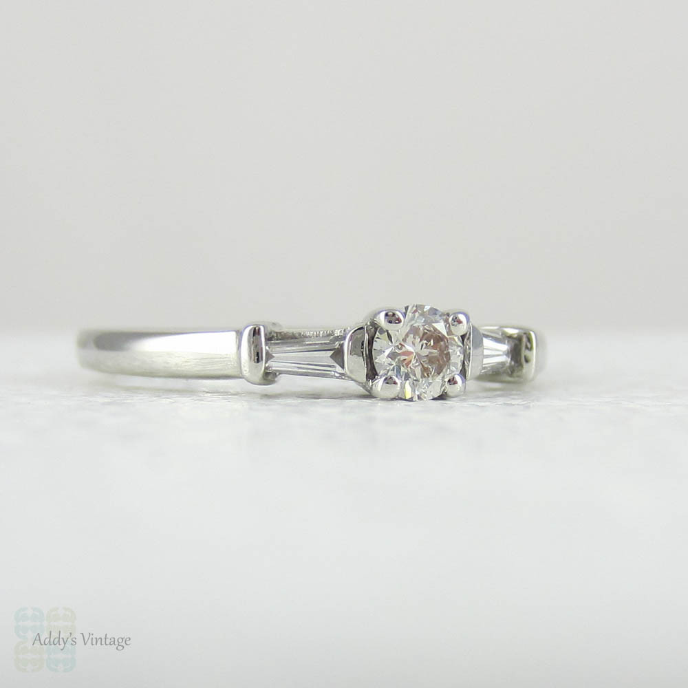 Estate Platinum Round Brilliant Diamond Engagement Ring with Tapered Baguette Accent Diamonds.