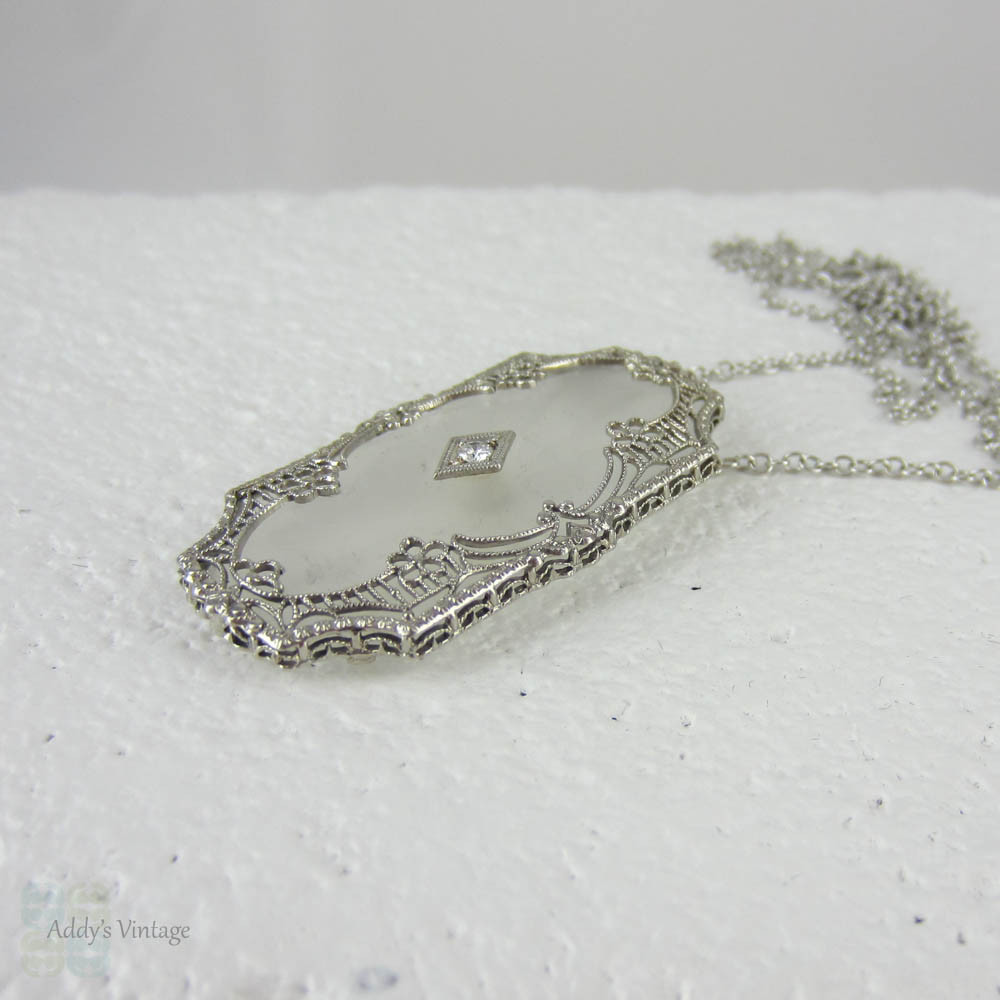 Art Deco Pendant. Camphor Glass, Diamond and White Gold Filigree Necklace. Lacey Floral Filigree with Milgrain Detail, Circa 1920s.