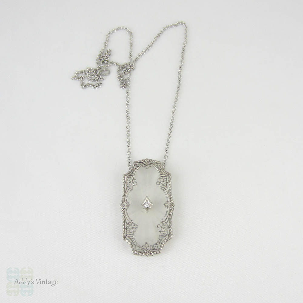 Art Deco Pendant. Camphor Glass, Diamond and White Gold Filigree Necklace. Lacey Floral Filigree with Milgrain Detail, Circa 1920s.