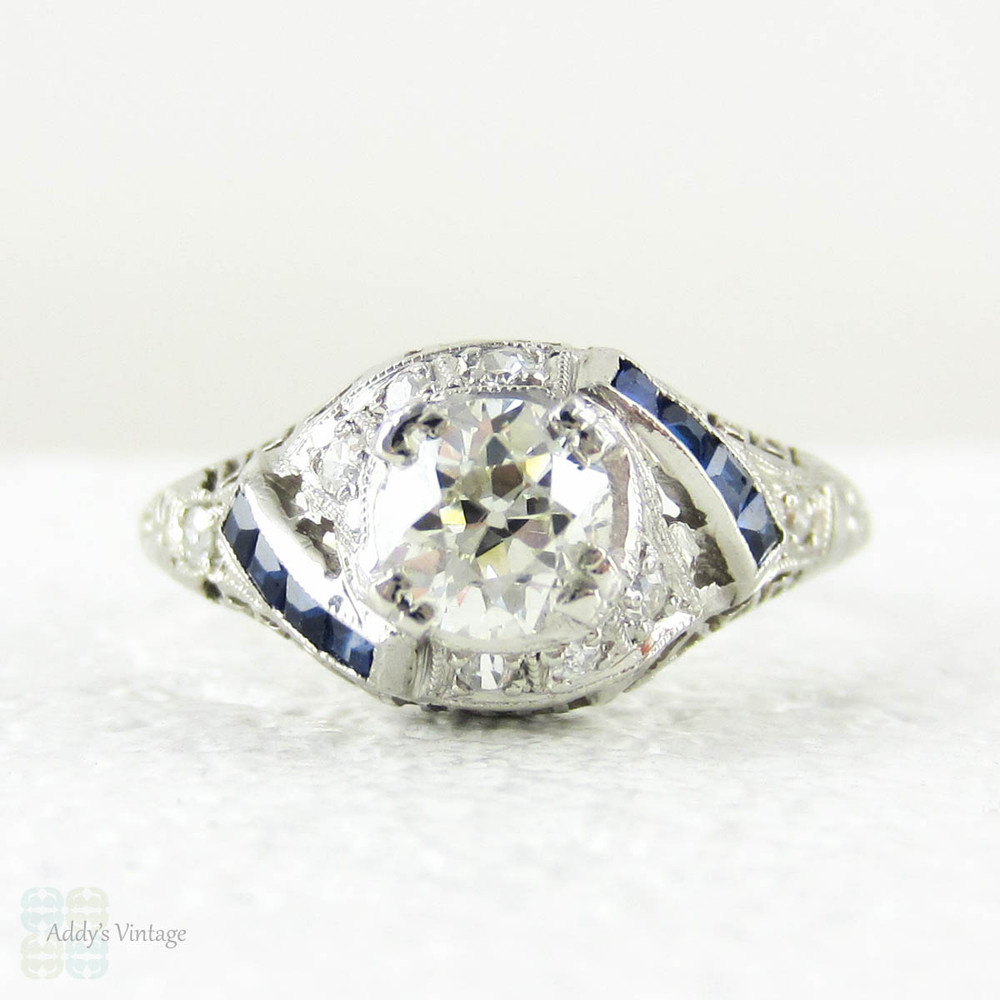 Edwardian Platinum Diamond Engagement Ring, Old European Cut Diamond in Filigree Setting with Sapphire Accents, Circa 1910s.