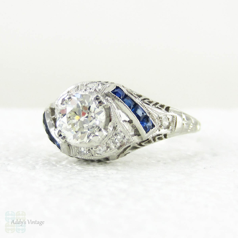 Edwardian Platinum Diamond Engagement Ring, Old European Cut Diamond in Filigree Setting with Sapphire Accents, Circa 1910s.