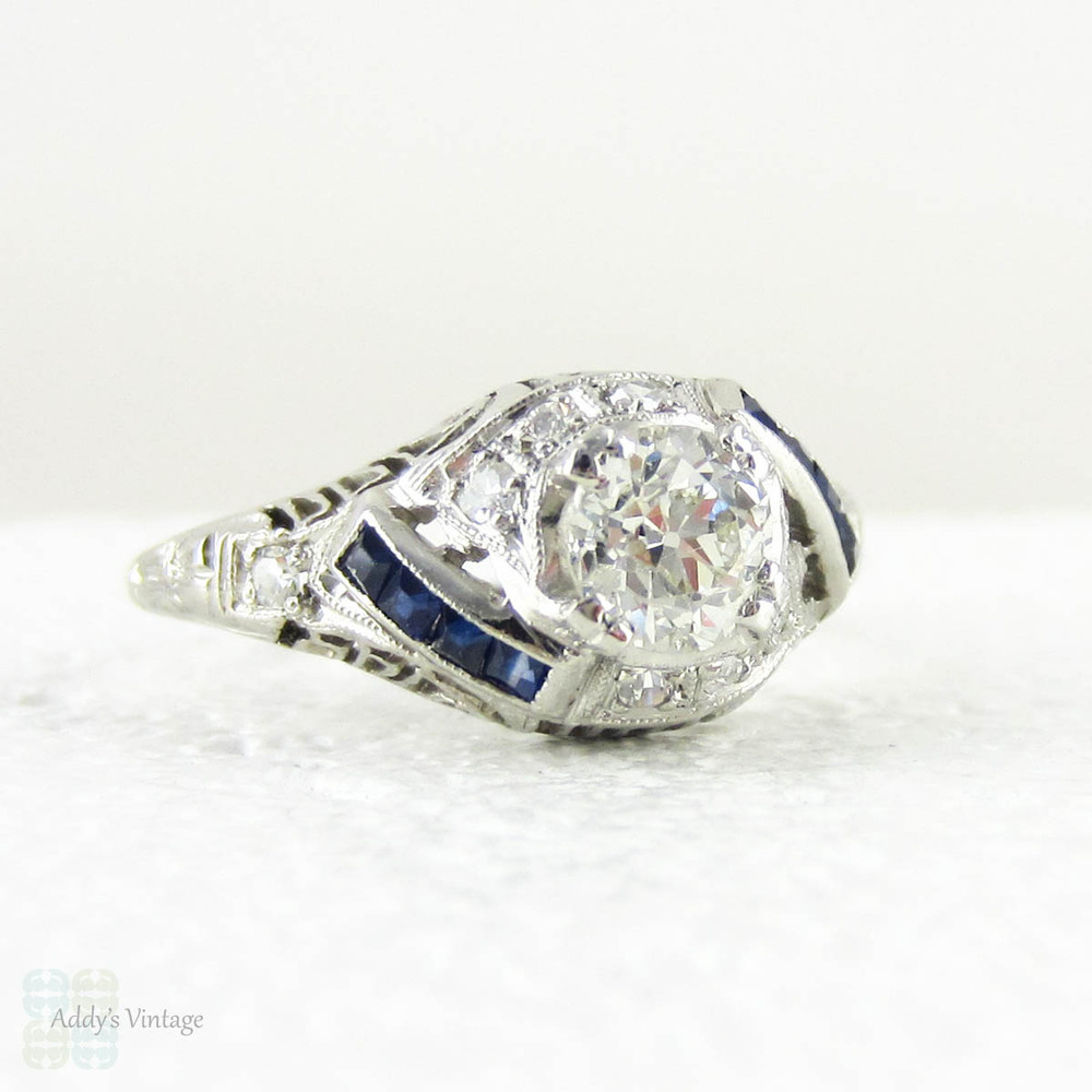 Edwardian Platinum Diamond Engagement Ring, Old European Cut Diamond in Filigree Setting with Sapphire Accents, Circa 1910s.