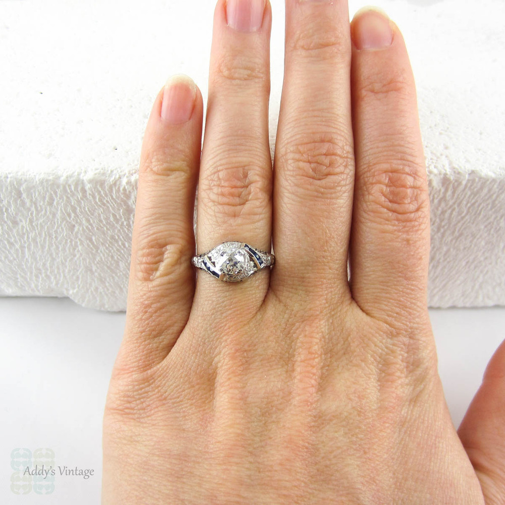 Edwardian Platinum Diamond Engagement Ring, Old European Cut Diamond in Filigree Setting with Sapphire Accents, Circa 1910s.