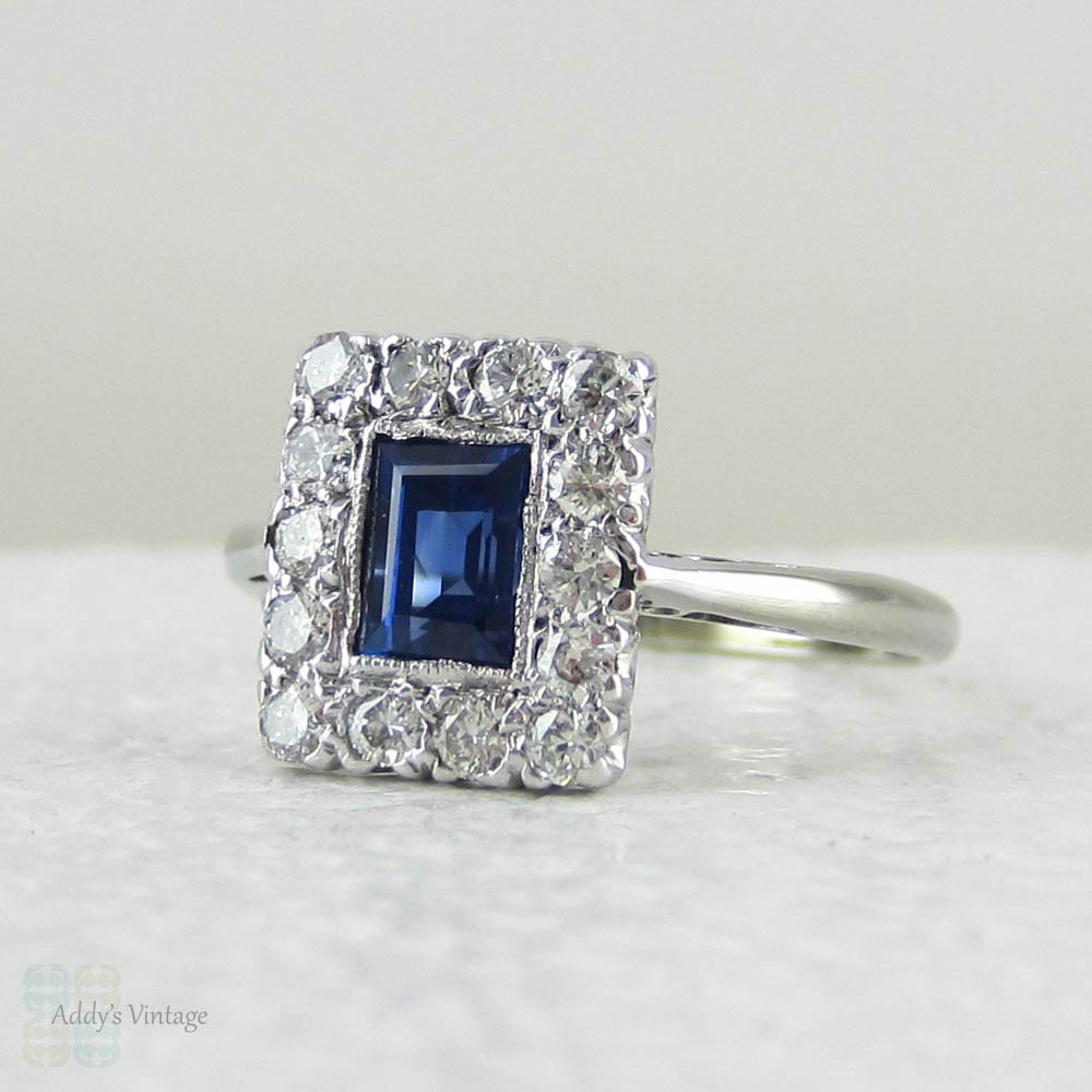 Art Deco Sapphire & Diamond Engagement Ring. Emerald Cut Blue Sapphire with Transitional Cut Diamond Halo in 18 Carat Gold & Platinum.