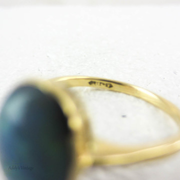 Art Nouveau Opal Doublet Ring, Black Opal Cabochon Bezel Set 18 Carat Yellow Gold Solitaire Setting, Circa 1910s.