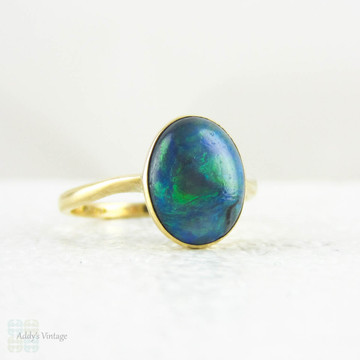Art Nouveau Opal Doublet Ring, Black Opal Cabochon Bezel Set 18 Carat Yellow Gold Solitaire Setting, Circa 1910s.