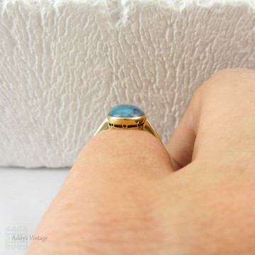 Art Nouveau Opal Doublet Ring, Black Opal Cabochon Bezel Set 18 Carat Yellow Gold Solitaire Setting, Circa 1910s.