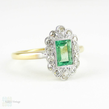 Art Deco Emerald & Diamond Engagement Ring. Light Green Emerald Cut Emerald with Fan Shaped Diamond Halo. Circa 1920s, 18ct & Platinum.