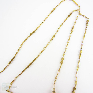 BALANCE. Art Nouveau 15ct Gold Necklace, Fancy Trombone Link Chain with Large Knot Design Pendant and Dog Clip for Pendant, Circa 1910s.