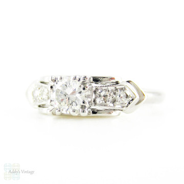 Mid 20th Century Diamond Engagement Ring, Round Brilliant Cut Diamond in Bow Style Platinum Setting. 0.31 ctw, Circa 1940s.