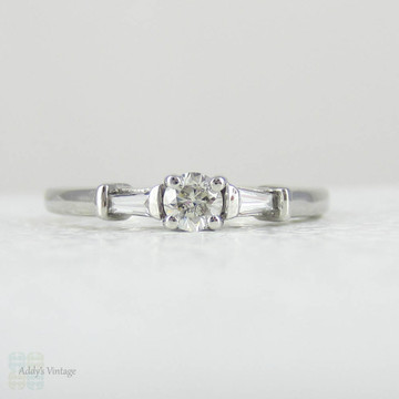 Estate Platinum Round Brilliant Diamond Engagement Ring with Tapered Baguette Accent Diamonds.