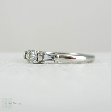 Estate Platinum Round Brilliant Diamond Engagement Ring with Tapered Baguette Accent Diamonds.