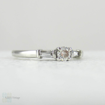 Estate Platinum Round Brilliant Diamond Engagement Ring with Tapered Baguette Accent Diamonds.