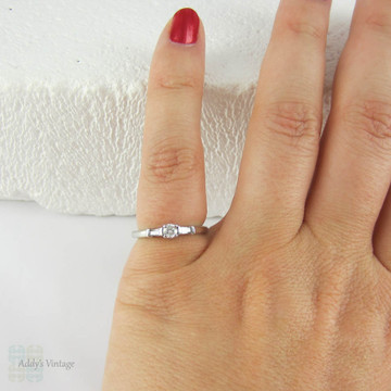 Estate Platinum Round Brilliant Diamond Engagement Ring with Tapered Baguette Accent Diamonds.