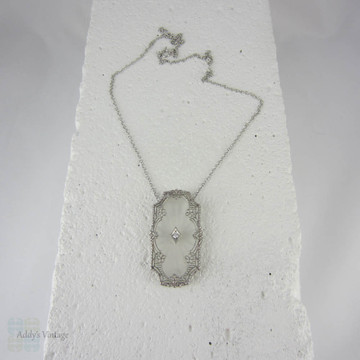 Art Deco Pendant. Camphor Glass, Diamond and White Gold Filigree Necklace. Lacey Floral Filigree with Milgrain Detail, Circa 1920s.