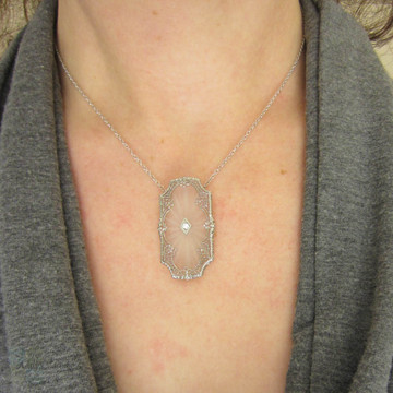 Art Deco Pendant. Camphor Glass, Diamond and White Gold Filigree Necklace. Lacey Floral Filigree with Milgrain Detail, Circa 1920s.