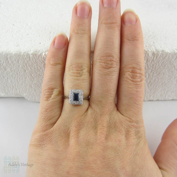 Art Deco Sapphire & Diamond Engagement Ring. Emerald Cut Blue Sapphire with Transitional Cut Diamond Halo in 18 Carat Gold & Platinum.