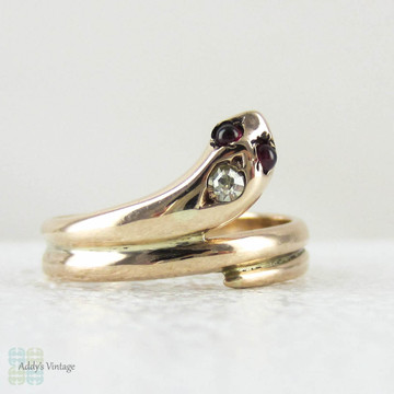 Antique Snake Ring, 9 Carat Rose Gold Coiled Snake Ring with Garnet Eyes & Diamond, Circa 1900s.