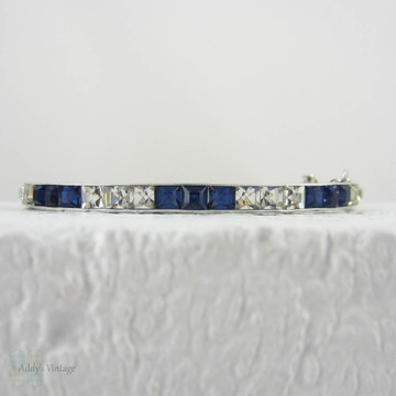 Art Deco Sapphire Blue & Clear Paste Bangle Bracelet, Channel Set Square Paste in Floral Engraved Sterling Silver Bangle, Circa 1920s.