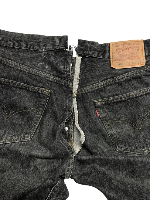 Jeans waist alteration with the waistband and center-back seam opened for a professional waist reduction without darts.