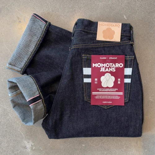 Folded Momotaro #100 Classic Straight GTB Stripes 15.7 oz Japanese selvedge jeans displayed on the floor of Williamsburg Garment Company's Brooklyn denim store.