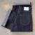 Folded indigo Momotaro women's Super Wide jeans showing the back pocket, white leather patch and turned-up selvedge cuffs.